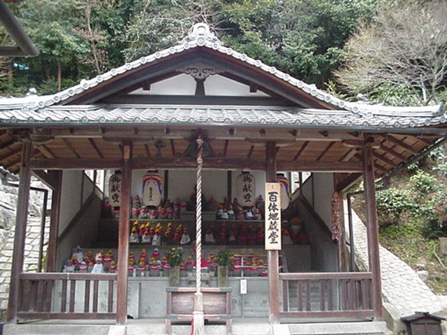 Small shrine featuring
          stone dolls